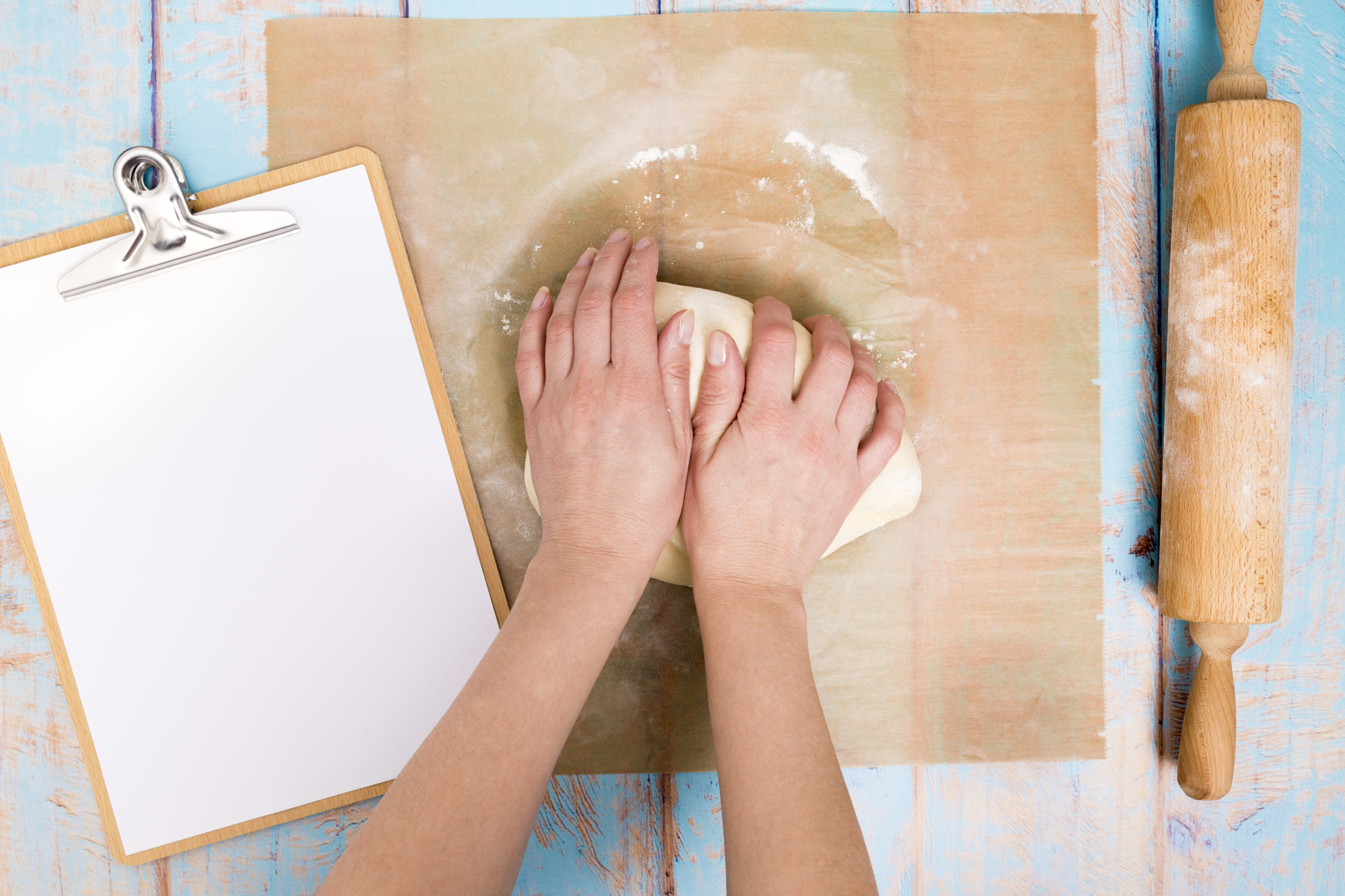 Hands preparing dough with recipe card